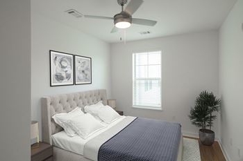 A bedroom with a bed and a ceiling fan